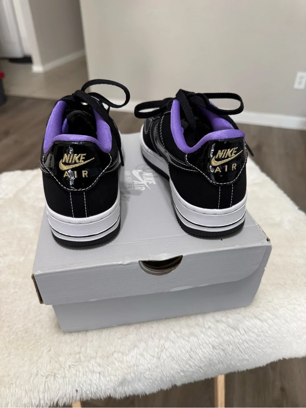 Nike Kids Black Sneakers with Purple Lining and Gold Lace Accent